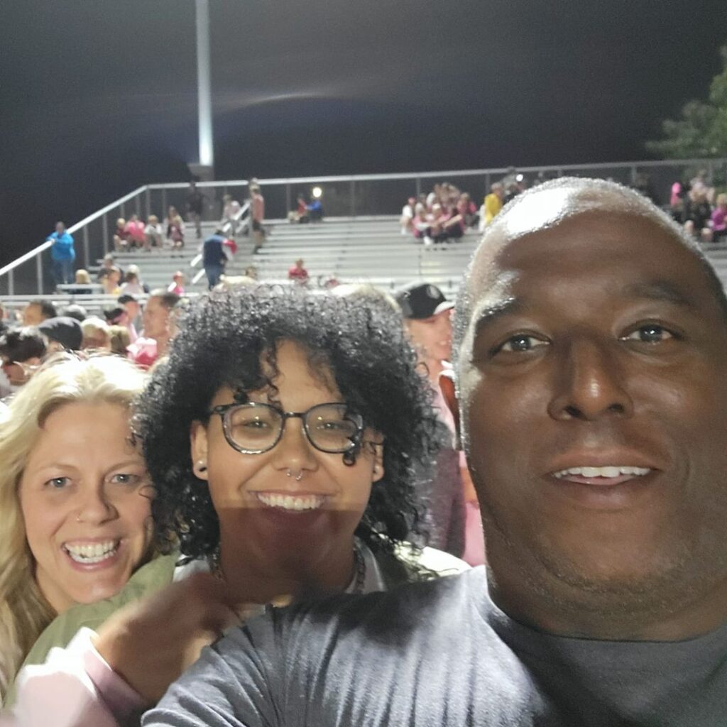 Harvie with wife and daughter at football game